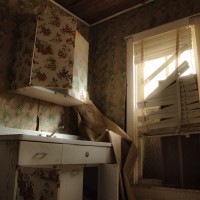 Shutting Out the Light - Broken blinds and boarded windows keep this kitchen in darkness.